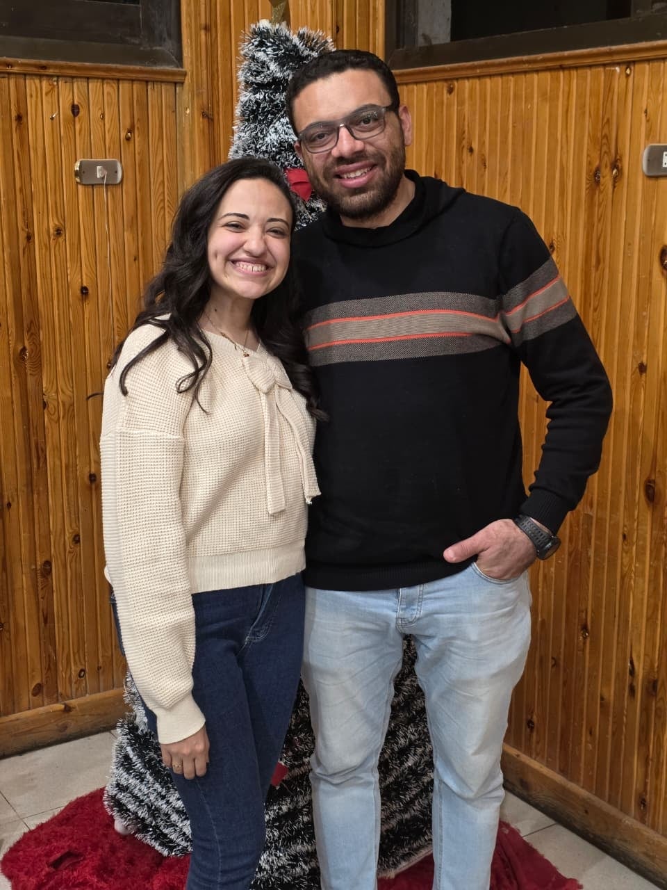 Nada and John beside a Christmas tree