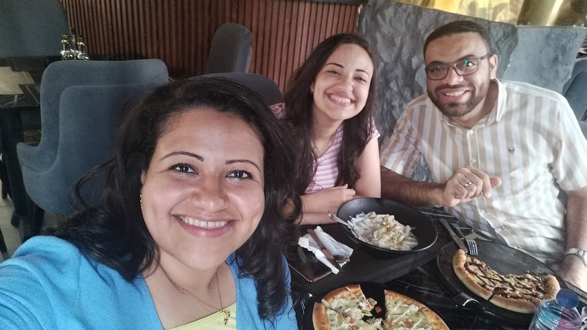 Nada and John at dinner with a friend
