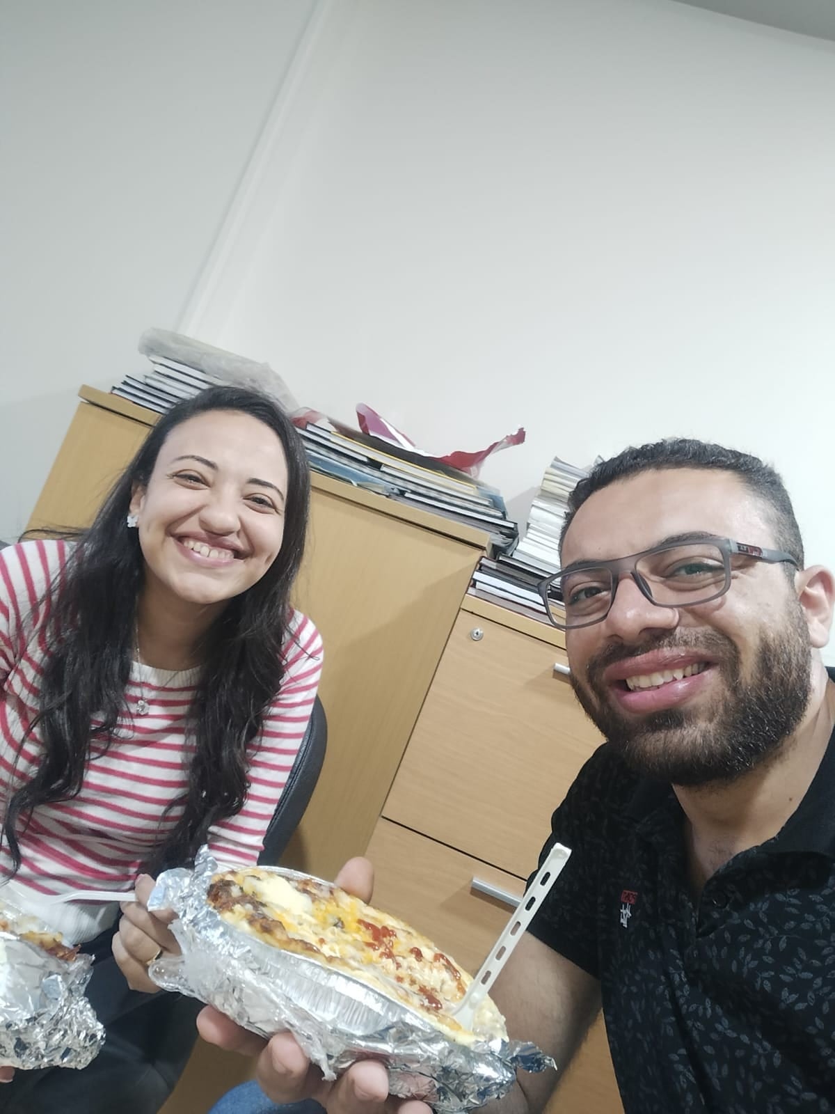 Nada and John sharing lunch at the office