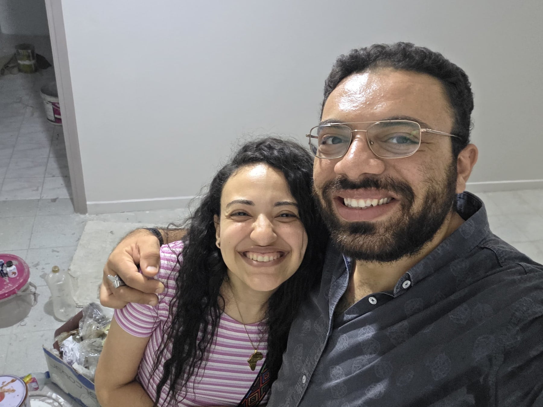 Nada and John in a selfie inside their home being prepared