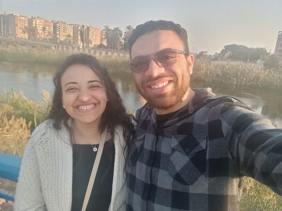 A sunset selfie of Nada and John by the river